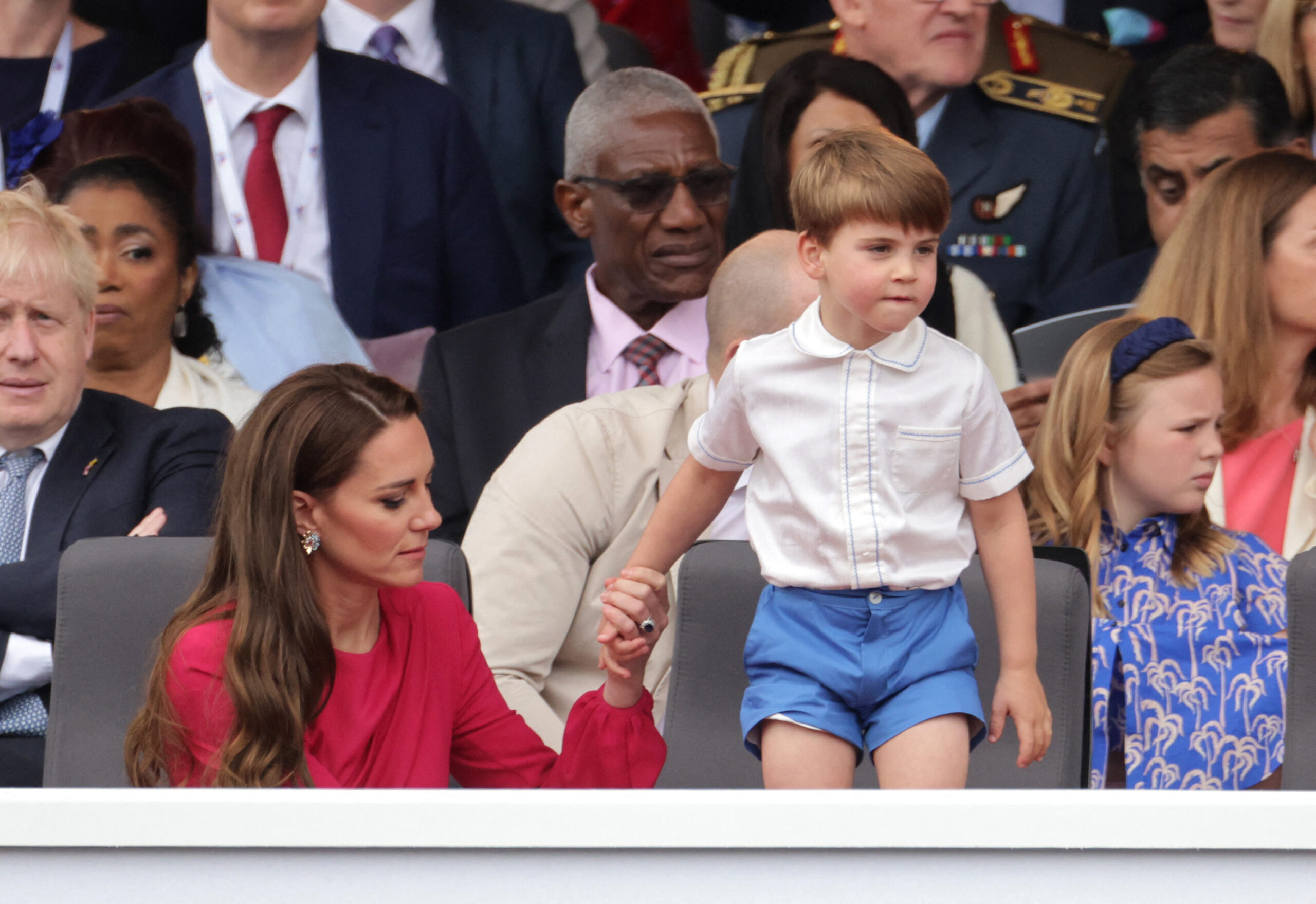 Britain's Catherine, Duchess of Cambridge, holds the hand of her son Britain's Prince Louis of Cambridge as he stands up during the Platinum Pageant in London on June 5, 2022 as part of Queen Elizabeth II's platinum jubilee celebrations. The curtain comes down on four days of momentous nationwide celebrations to honour Queen Elizabeth II's historic Platinum Jubilee with a day-long pageant lauding the 96-year-old monarch's record seven decades on the throne. (Photo by Chris Jackson / POOL / AFP) (Photo by CHRIS JACKSON/POOL/AFP via Getty Images)