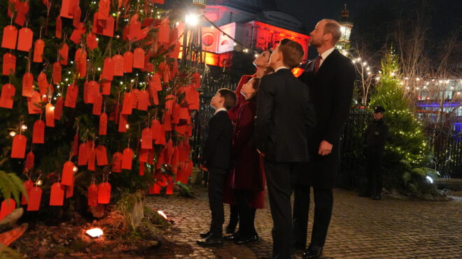 LONDON, ENGLAND - DECEMBER 6: The Prince and Princess of Wales with their children Prince George, Princess Charlotte and Prince Louis look at messages on the Kindness Tree ahead of the 'Together At Christmas' Carol Service at Westminster Abbey on December 6, 2024 in London, England. The Prince and Princess of Wales, along with other members of the Royal Family, attended the annual carol service. Led by The Princess and supported by The Royal Foundation, the event offered a chance to pause and reflect on the profound values of love, compassion, and the vital connections we share—particularly during life's most challenging moments. The service also highlighted remarkable individuals from across the UK who have demonstrated extraordinary kindness, empathy, and support within their communities. (Photo by Jordan Pettitt - WPA Pool/Getty Images)