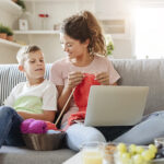 Mom knitting with son on couch