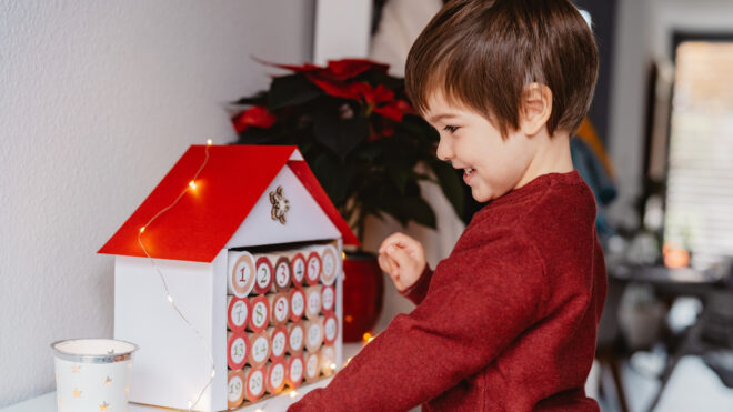 Little boy with a DIY advent calendar