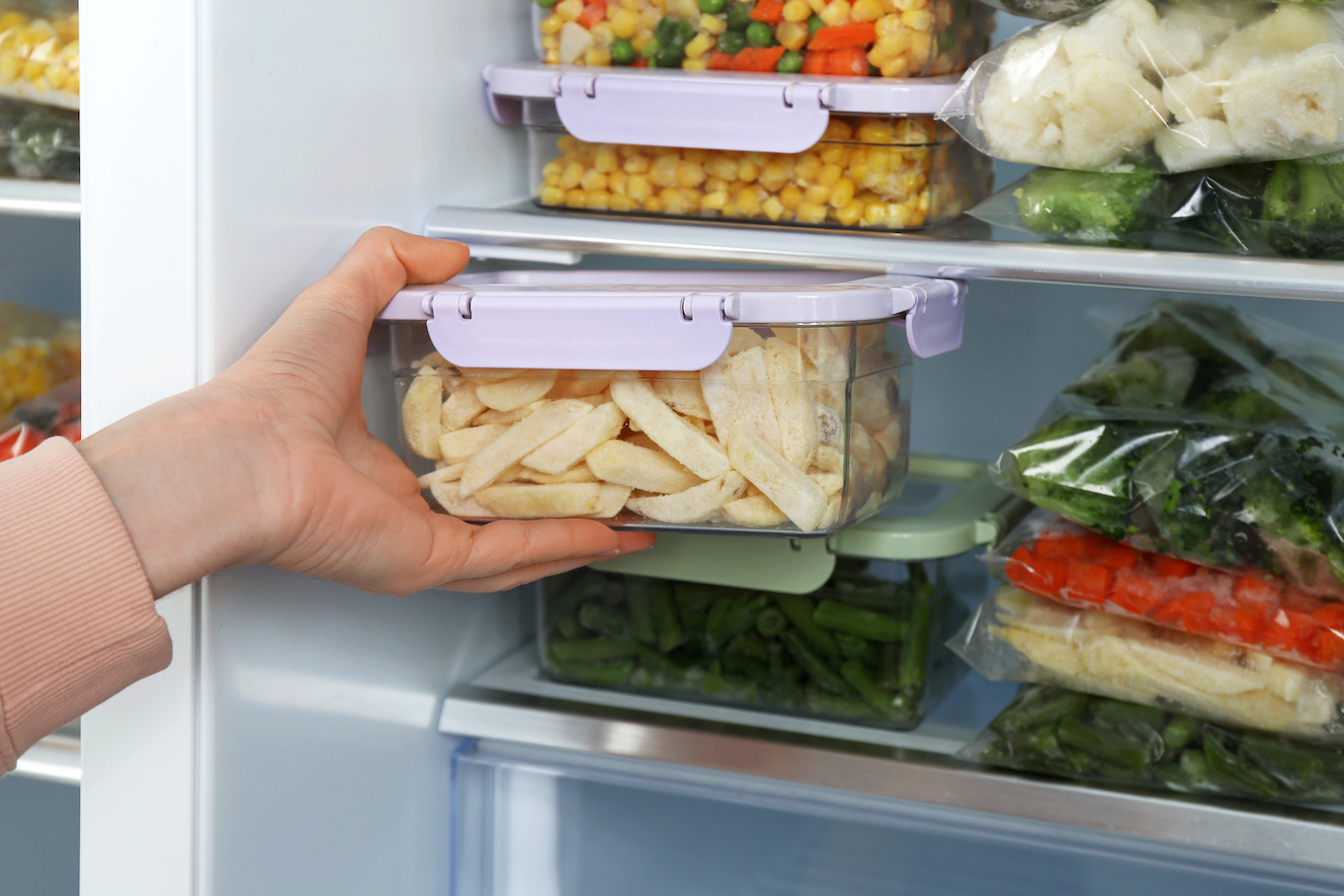 Woman putting food in freezer