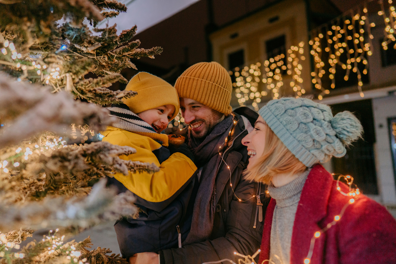 Family outside with Christmas lights