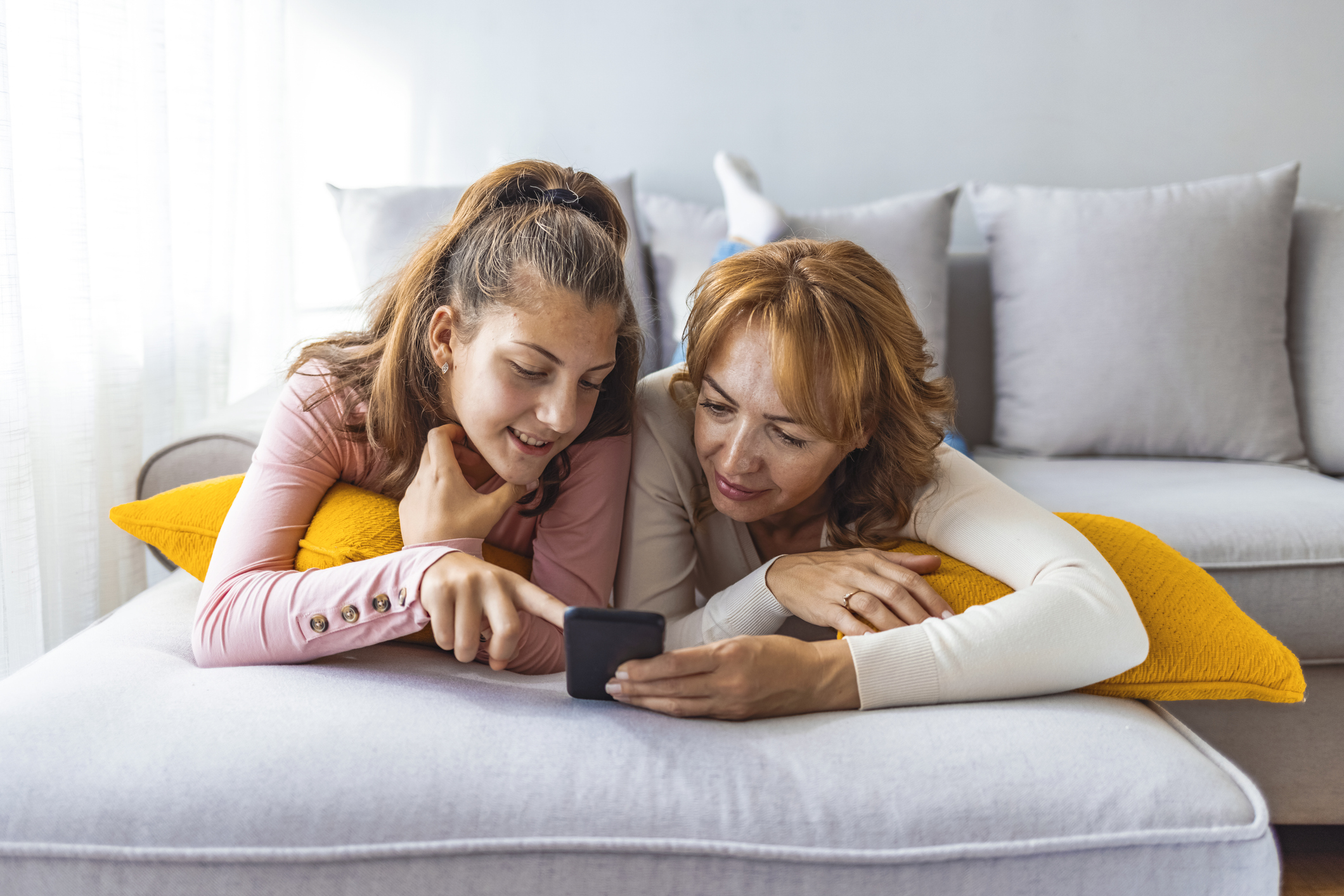 Mother and daughter using a smartphone