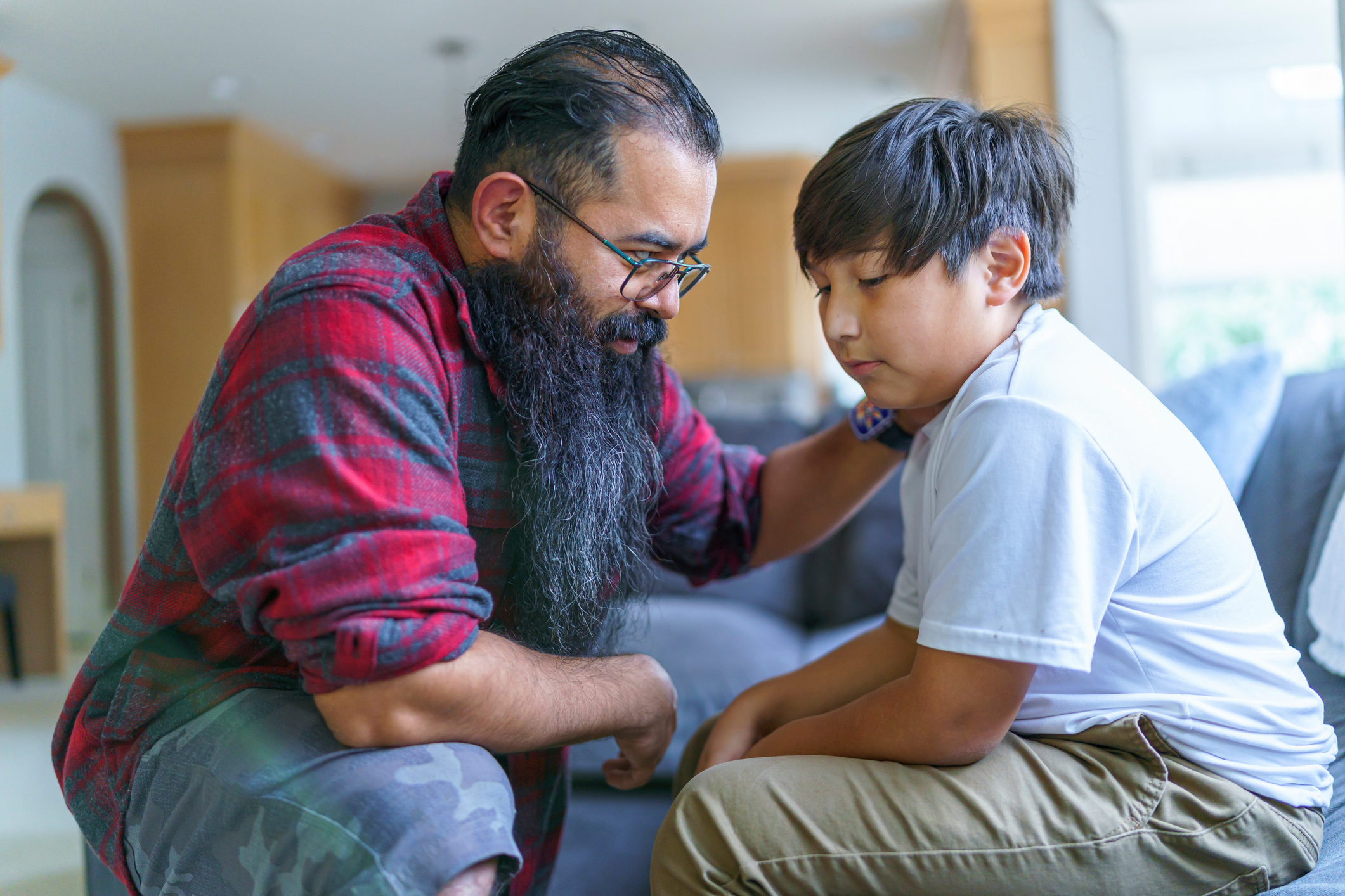 Dad having serious conversation with his son