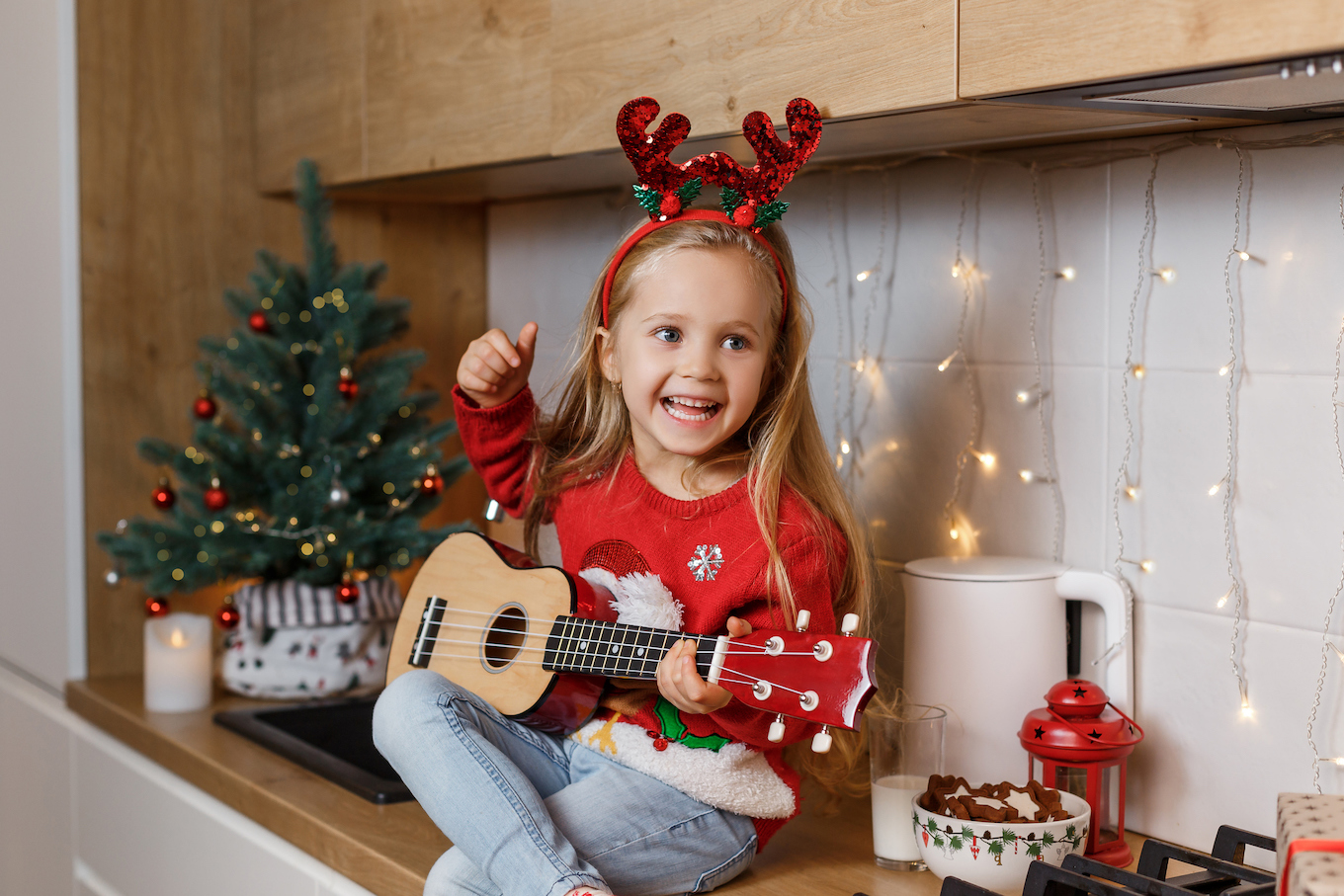 Girl playing the ukulele on Christmas