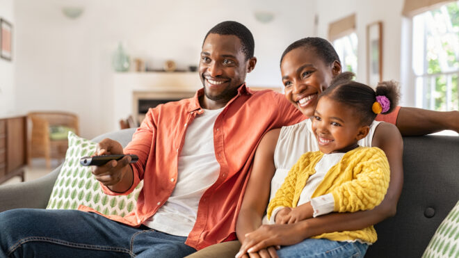 Parents and daughter watching TV