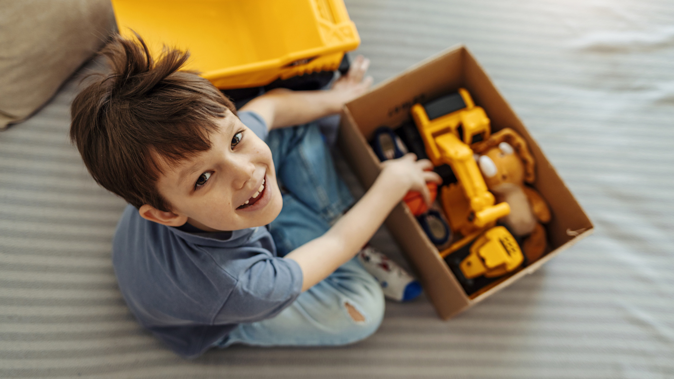 Smiling kid playing with toys