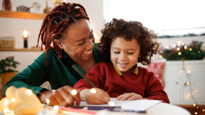 Mom and son at Christmas writing a letter