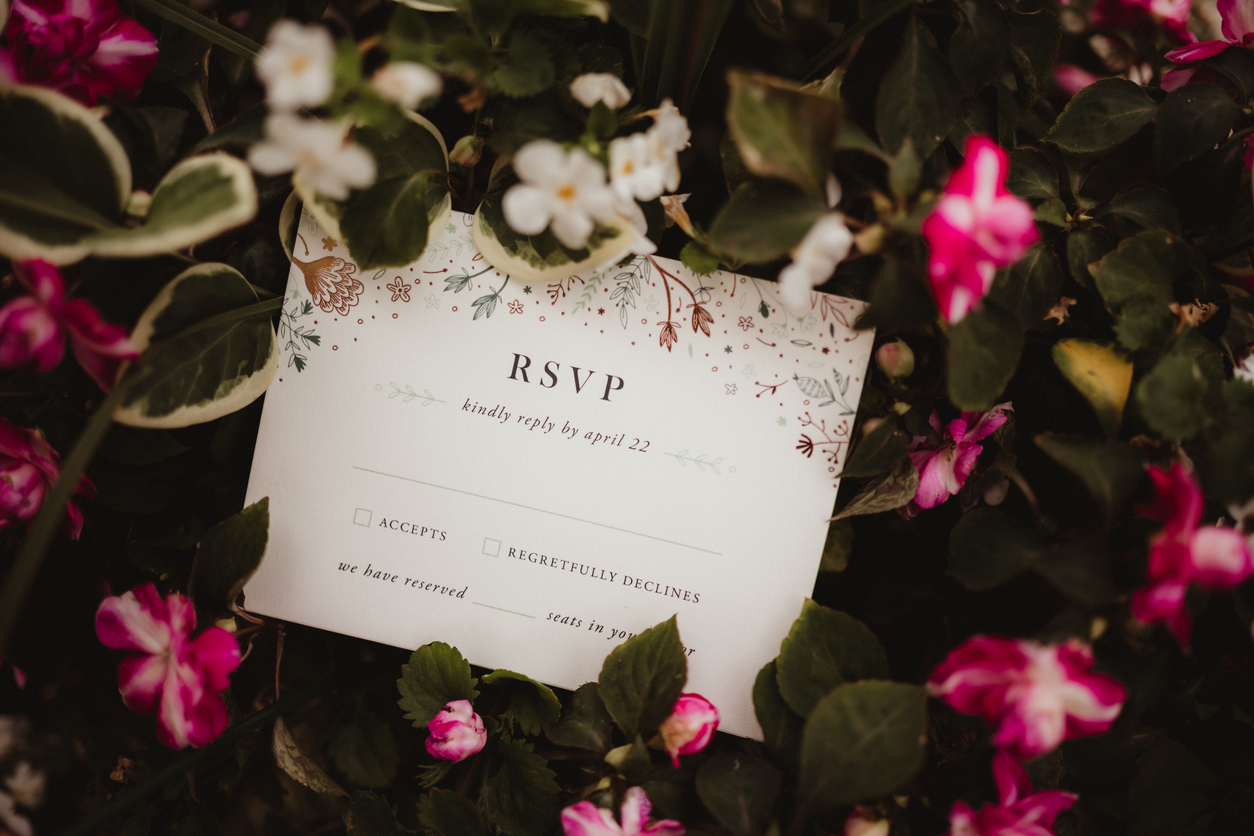 RSVP card from a wedding invitation on a bed of flowers