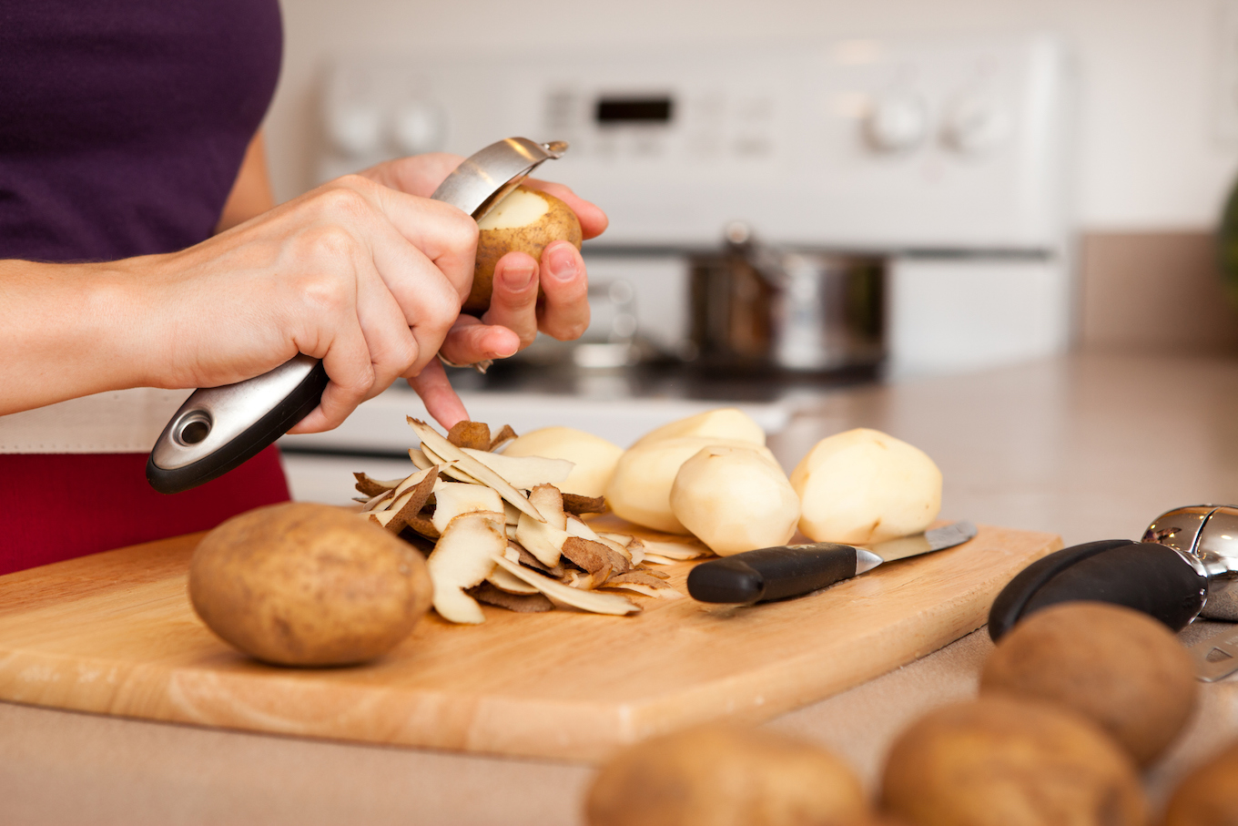 Woman peeling potatoes