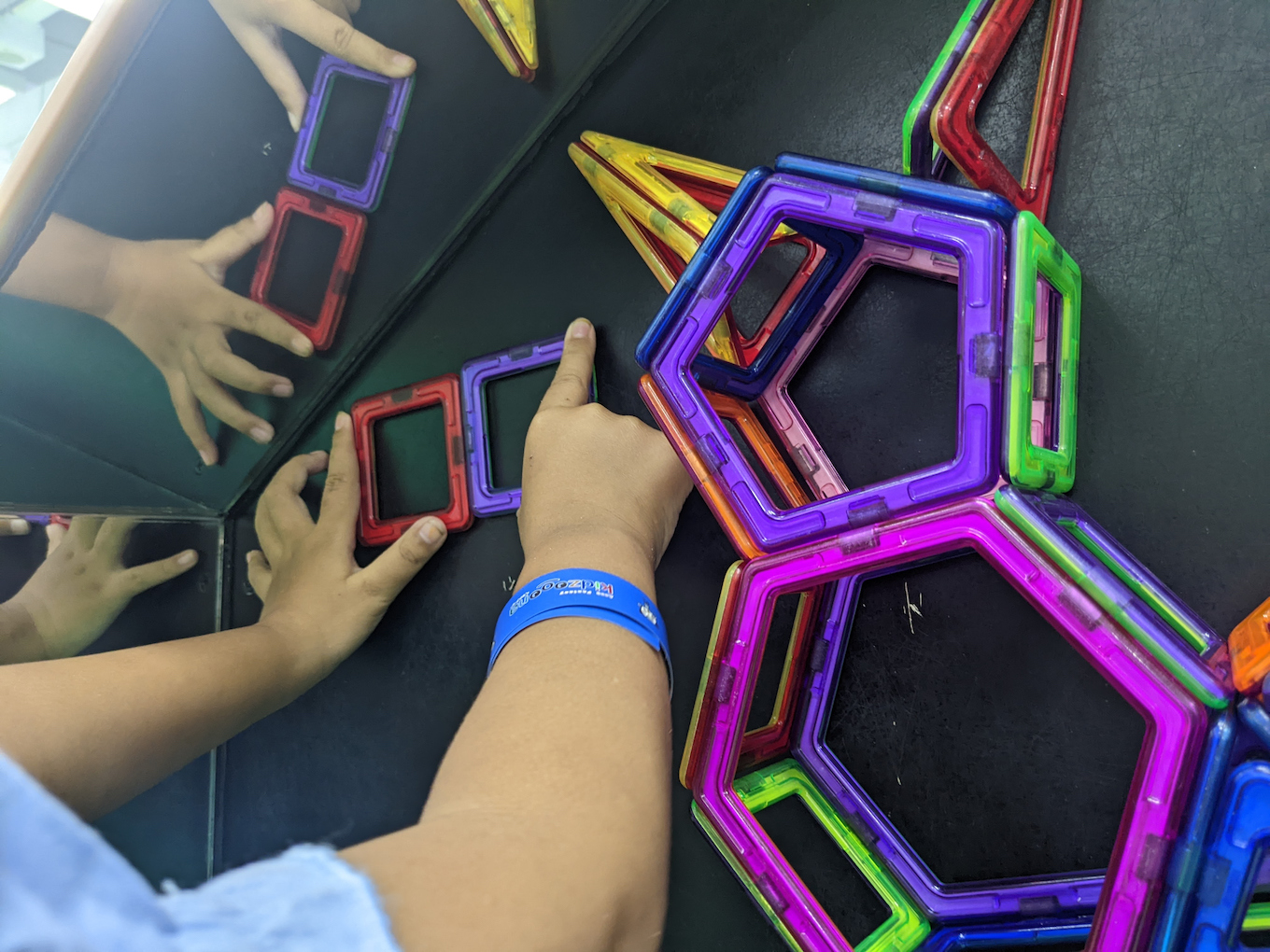 A child playing with magnetic tiles