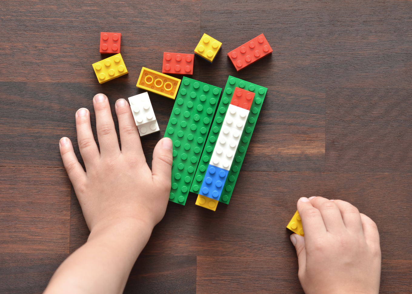 Kid playing with Lego bricks