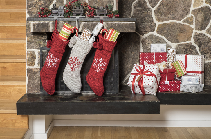 Stuffed stockings hanging on a fireplace on christmas morning