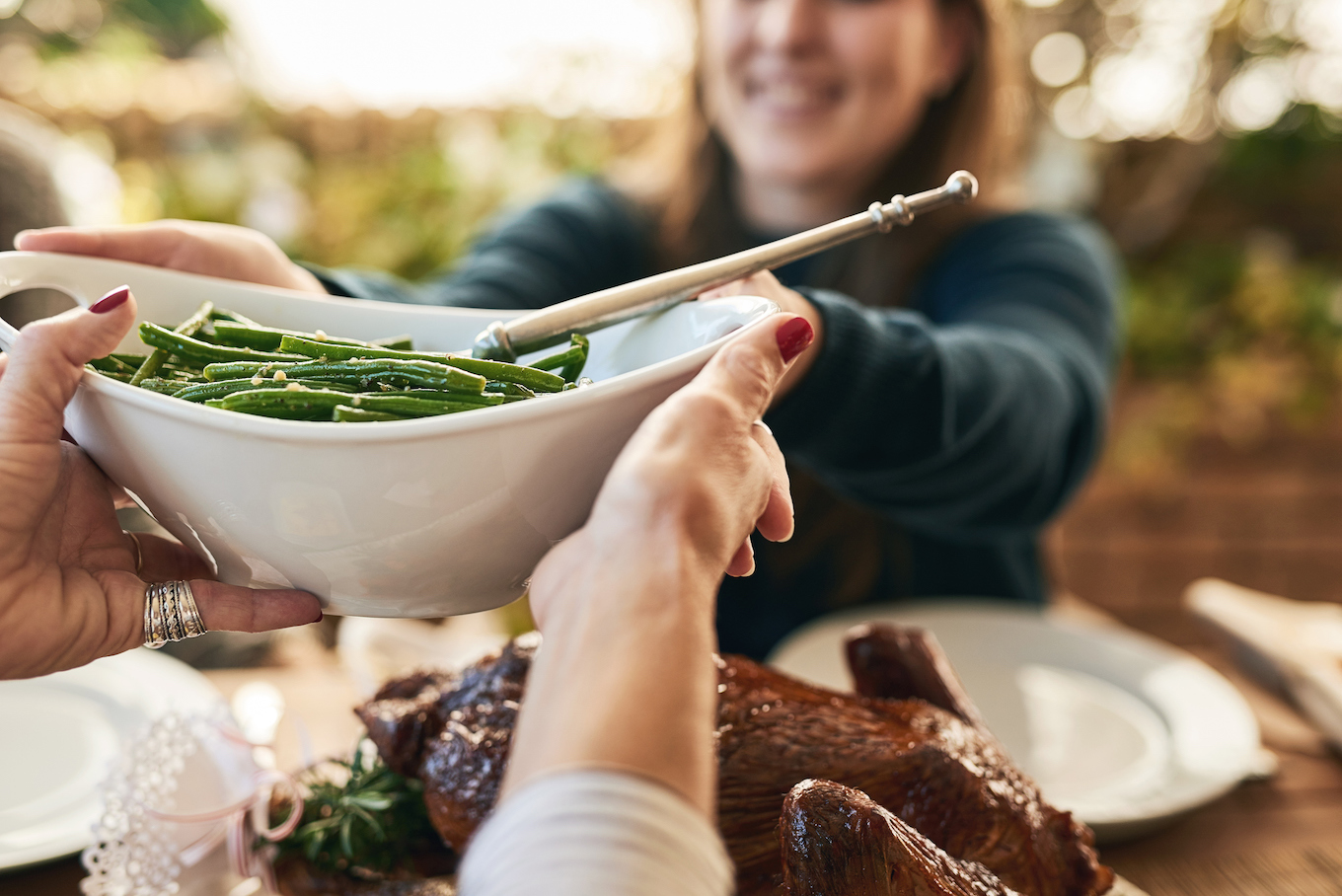 Passing a bowl of green beans