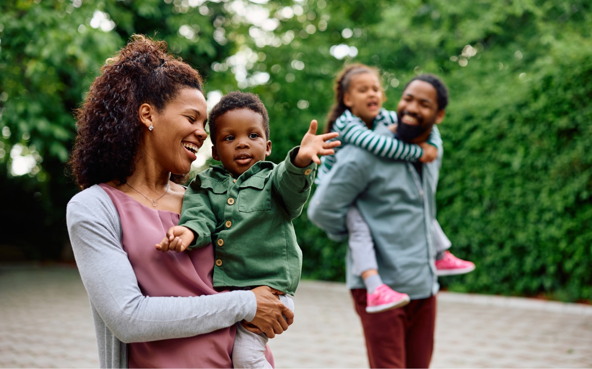 Black family smiling and walking in the park