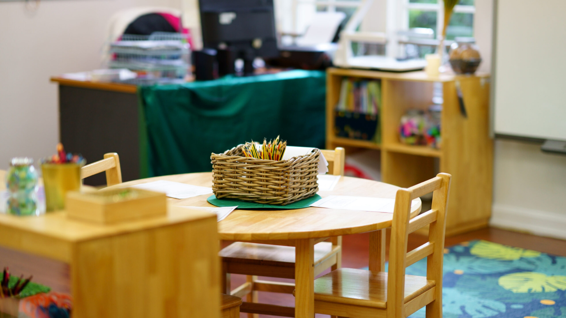 table and chairs in an empty preschool classroom